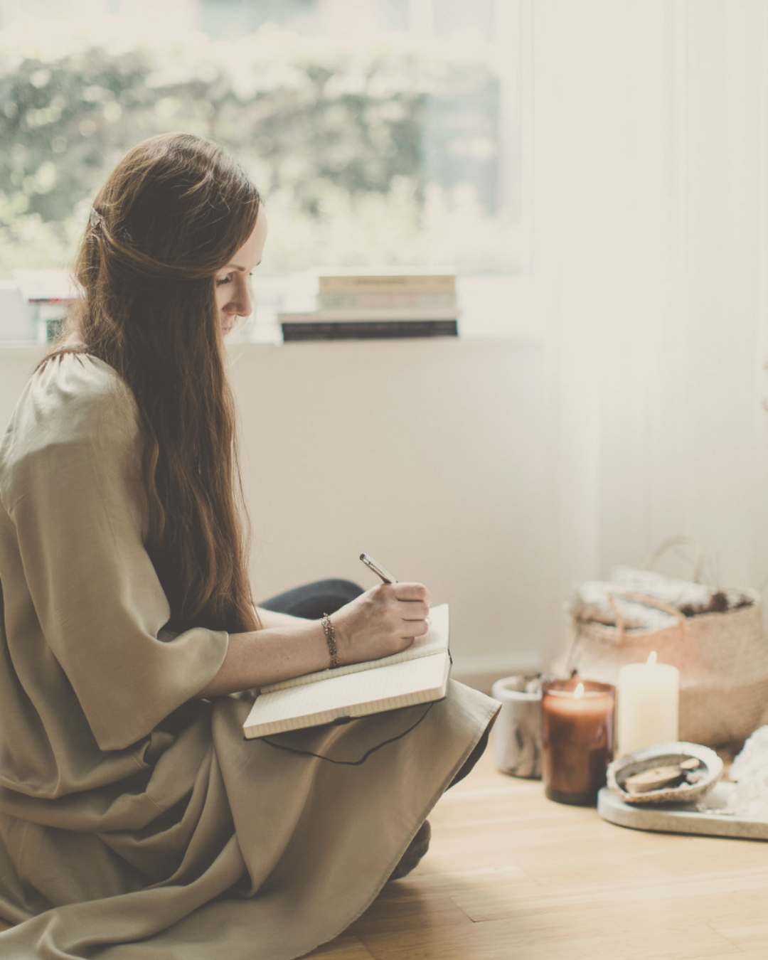 woman mindfully journaling with candle lights in a beautiful atmosphere