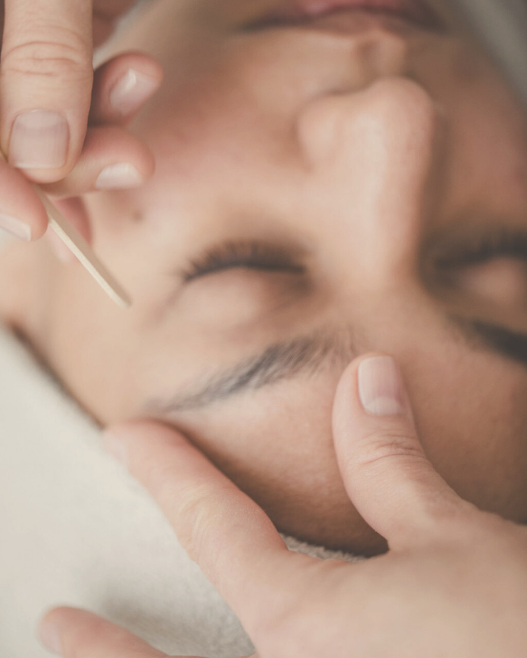 woman receiving natural eyebrow forming