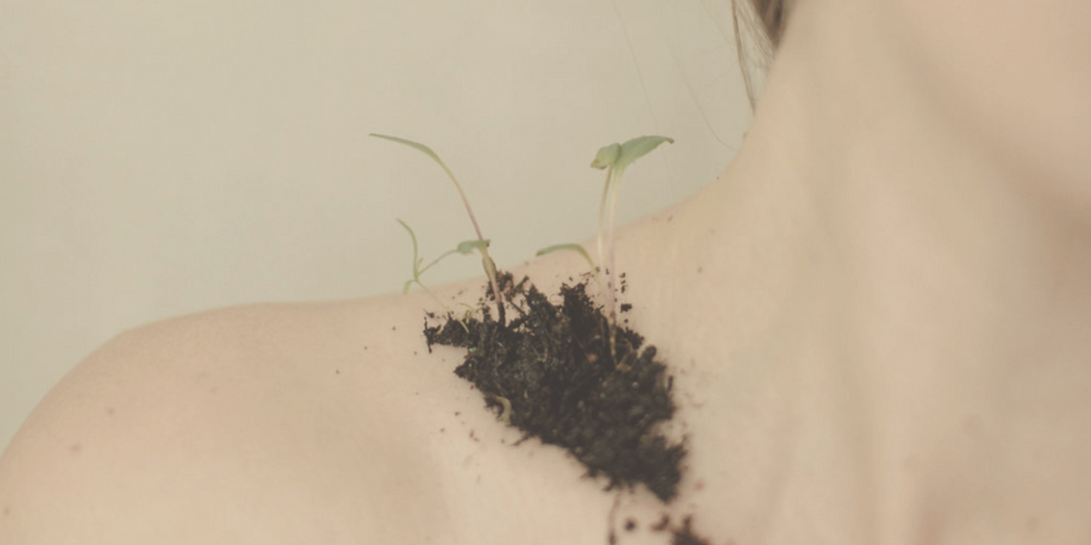 women's collarbone with soul and sprouts 