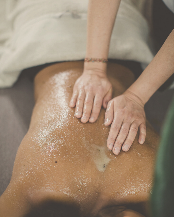 woman enjoying a back cleanse with ayurvedic herbs - a detoxing body scrub massage
