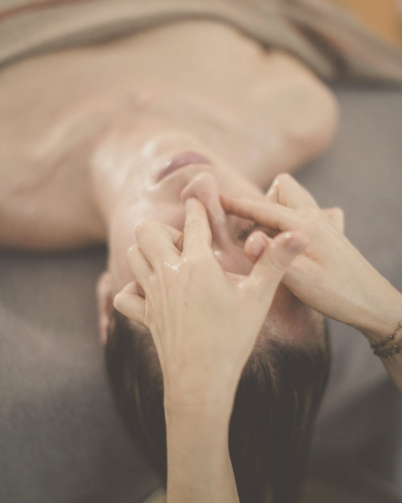 woman receiving an Ayurvedic Mukhabhyanga - head, scalp and face massage