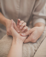 close-up of the hands of a woman giving a hand massage to another woman